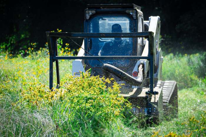 BrushBoys brush hogging an overgrown field